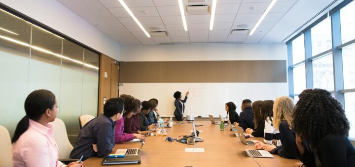 Business meeting with diverse team discussing projects in a modern conference room.