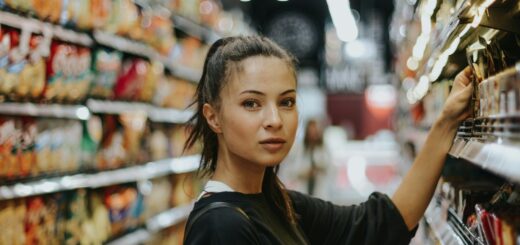 woman selecting packed food on gondola